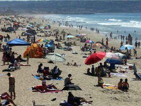 Crowds line the shore at Manhattan Beach, Calif.