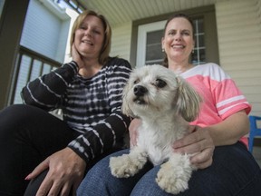 Astrid Frauscher, left, and Cheyenne Steffen pose with Hudson, a bichon-shih tzu, at Frauscher's home in Calgary on Thursday, June 18, 2015. Hudson became lost from the Frauscher home, and was recovered in part through a retweet by Mayor Naheed Nenshi.