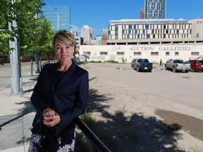 Susan Veres, Vice President, Marketing and Communications with the Calgary Municipal Land Corp stands next to a parcel of land in the East Village which has been sold to a developer.