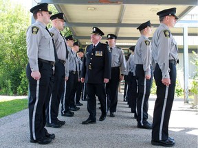Brian Whitelaw, coordinator for public safety with Calgary Transit, leads an inspection of 13 new peace officers before their graduation ceremony at Fort Calgary on Thursday June 25, 2015.