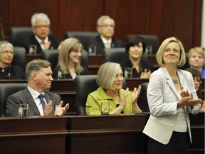 Premier Rachel Notley, right, and her caucus applaud following the swearing-in ceremony in the house of the Alberta Legislature June 1, 2015.