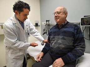 Dr. Thomas Jeerakathil, stroke neurologist checks the reflexes of stroke patient Richard Grynoch at the Kaye Edmonton Clinic in Edmonton, March 9, 2015. Acting when symptoms appear saves lives.