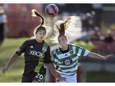 Seattle Sounders player Brianna Hooks, left, heads the ball at Stampeder Field in Calgary on Friday, June 19, 2015. The Foorhills WFC led the Seattle Sounders, 1-0, at the half in an exhibition game.