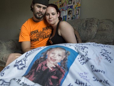 Brian and Kyla Woodhouse look at a t-shirt with a photo of their daughter Meika Jordan on it in their home in Calgary, on June 25, 2015. They just learned that the Crown is appealling the conviction in the Meika Jordan murder case.