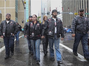 Kyla Guttman, left, and Brian Woodhouse leave the courthouse with the Bikers Against Child Abuse after finding out the final verdict in the Meika Jordan murder trial in Calgary, on June 3, 2015.