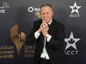 Gerry Dee celebrates his award for the Best Actor in a continuing leading comedic role for the show "Mr. D" at the Canadian Screen Awards in Toronto on Sunday, March 3, 2013. Dee is at the Banff World Media Festival this week.