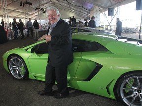 Developer Ken Mariash stands among the luxury cars during an event launching a new Meadows Mile auto mall overlooking Deerfoot Meadows Friday September 26, 2014.