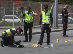 Police investigate the gas drive-off hit and run near the intersection of 16 Ave. and 17 St. N.W., in Calgary on Sunday.