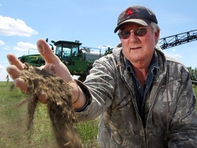 Hussar area farmer Steve Selgensen says while the situation is not dire yet, if the area does not get rain soon, the growing season might be impacted. He was busy spraying his wheat crops on June 16, 2015.  (Colleen De Neve/Calgary Herald)