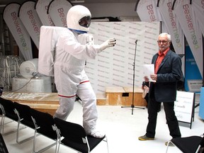 Astronaut Steve Nagy does a space walk on a chair alongside Jay Ingram, founder of Beakerhead,  Wednesday at the festival offices in Sunalta, where the festival released this year's lineup.