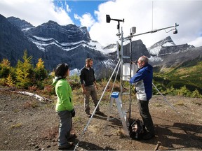May Guan and Angus Duncan with the University of Saskatchewan's Centre for Hydrology talk with centre director John Pomeroy at the site of a new weather station at Fortress Mountain ski area in September 2013.