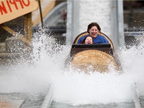 Katelyn Richter, 9, and her mom Rachelle Richter took advantage of shorter lines to hit the newly reopened Timber Falls log ride twice in a row as they braved the cool morning temperatures to hit the rides during the opening weekend of Calaway Park on May 17, 2015.