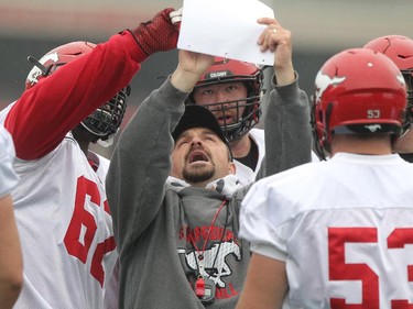 Calgary Stampeders Offensive Line Coach Pat DelMonaco talks strategy with his linemen during practice at McMahon Stadium Wednesday June 17, 2015.