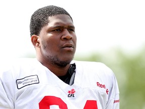 Offensive lineman Andre Ramsey takes a break between practice plays at McMahon Stadium on Monday.