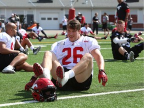 Stampeders fullback Rob Cote stretche on the McMahon Stadium field prior to a training camp practice on Wednesday.