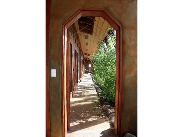 Looking into the Kinney earthship's long greenhouse, which serves as a main hallway and air barrier between the living space and the outdoors. It also produces vegetables year round.