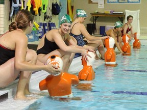 Members of the Calgary Winter Club's competitive lifeguarding team position 85 lb mannequins for fellow team members to retrieve during a drill on Tuesday May 26.