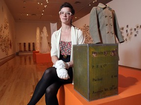 Lindsey Sharman, Curator of Art with the Founder's Gallery, with the manna box, a care package from the liberation of Holland, donated by Alfred Baum at the Military Museums. She will be opening the box during a ceremony on Saturday.