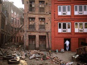 A Nepalese man who lost his family members goes inside his damaged house one month after the deadly 7.8 magnitude earthquake in Kathmandu, Nepal.