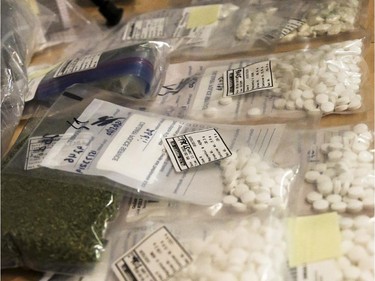 A variety of prescription and illegal drugs are shown at a press conference at the Calgary Police Headquarters in Calgary on Thursday, June 4, 2015.