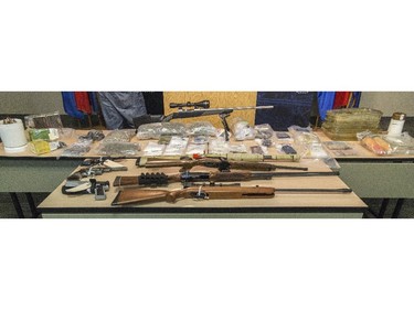 A collection of seized guns, drugs, and drug lab equipment shown following an arrest at the Calgary Police Headquarters in Calgary on Thursday, June 4, 2015.