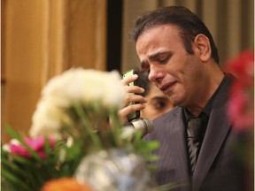 Ahmad Nourani Shallo talks to his father-in-law via Skype in front of over 150 friends, family and supporters that overflowed the halls at Pierson's Funeral Services in Calgary, to honour the life of his wife Maryam Rashidi Ashtaini.