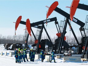 Pumps work at a ConocoPhillips natural gas well site west of Red Deer on March 5, 2013.