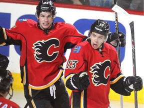 Colleen De Neve/ Calgary Herald CALGARY, AB --APRIL 21, 2015 -- Calgary Flames left winger Johnny Gaudreau, right, celebrated his goal with teammates, from left, centre Jiri Hudler, defenceman Dennis Wideman, and centre Sean Monahan after opening the scoring against the Vancouver Canucks during first period NHL playoff action in game 4 of the series at the Scotiabank Saddledome in Calgary on April 21, 2015.  (Colleen De Neve/Calgary Herald) (For Sports story by Scott Cruickshank) 00064432B SLUG: 0422-Flames Canucks Game 4