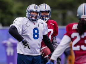 Nik Lewis, left, takes part in the Montreal Alouettes training camp at Bishop's University in Lennoxville, Quebec on Sunday. It's a big change to not see him jawing away at Stamps camp.