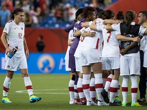 Canada's Christine Sinclair joins teammate following their 1-1 tie against the Netherlands during second half Women's World Cup soccer action Monday in Montreal.