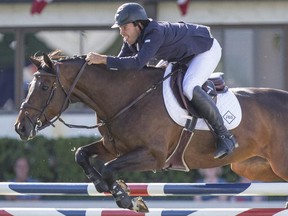 Jack Hardin Towell Jr. riding Emilie De Diamant AS jumps off for the $35,000 Encana Cup at Spruce Meadows in Calgary on Friday, June 5, 2015.