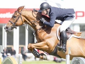 McLain Ward of Brewster, N.Y., completes a jump on Rothchild during his winning run in the CP Grand Prix on the final day of the Spruce Meadows Continental on Sunday.