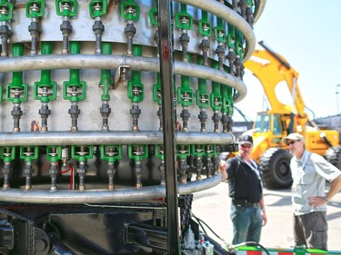 Visitors check out the TCI Burners waste combustion exhibit at the Global Petroleum Show in Calgary on Tuesday June 9, 2015.