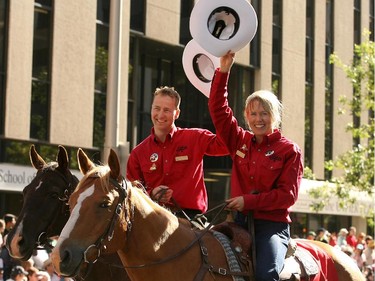 2006 StampedeParade marshals Bjornar Hakensmoen and Sara Renner wave to the crowd during the parade.  The theme that year was "A World-Class Act of Sportsmanship."