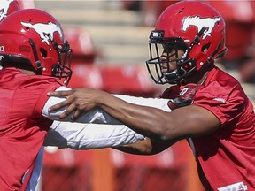 Brandon Harper, right, runs a drill during Stampeders training camp at McMahon Stadium in Calgary, on June 5, 2015.