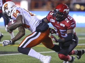 Calgary Stampeders defensive back Keon Raymond tackles B.C.'s Emmanuel Arceneaux during a game last September. Under new CFL rules, defenders aren't allowed to touch receivers five yards beyond the line of scrimmage, something Raymond is vehemently opposed to.