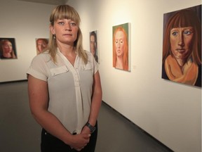 Crystal Schick/ Calgary Herald CALGARY, AB -- Teresa Coulter, a self taught artist and EMT, stands surrounded by the portraits she's painted displayed as an exhibition called Dirty Sock Drawer, at The Little Gallery in the U of C art building, in Calgary, on June 18, 2015. --  (Crystal Schick/Calgary Herald) (For City story by  Chris Nelson) 00066239A