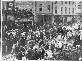 The streets are lined four deep for the 1912 Calgary Stampede parade.