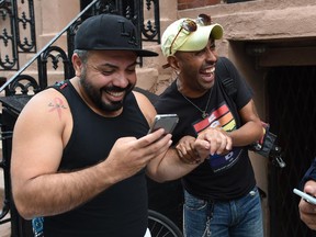 People celebrate outside the Stonewall Tavern in the West Village in New York on June 26, 2015. The US Supreme Court ruled Friday that gay marriage is a nationwide right, a landmark decision in one of the most keenly awaited announcements in decades and sparking scenes of jubilation. The nation's highest court, in a narrow 5-4 decision, said the US Constitution requires all states to carry out and recognize marriage between people of the same sex.