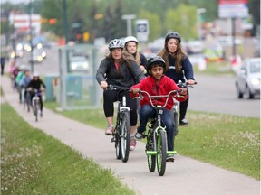 Students bike to Simon Fraser Junior High School during Bike to School Day in Calgary on June 2, 2015.