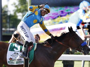 Victor Espinoza reacts after crossing the finish line with American Pharoah (5) to win the 147th running of the Belmont Stakes horse race at Belmont Park, Saturday, June 6, 2015, in Elmont, N.Y. American Pharoah is the first horse to win the Triple Crown since Affirmed won it in 1978.