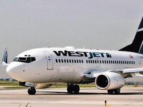 A WestJet plane taxis on the runway of Pearson International Airport in Toronto, Ontario, Canada, Wednesday, June 8, 2005.  Photographer:  Norm Betts/Bloomberg News. *CALGARY HERALD MERLIN ARCHIVE*

0617-biz-xFPwestjet