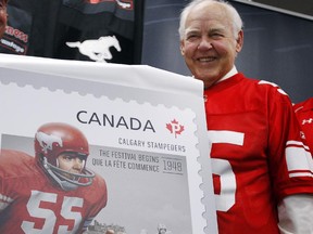 Calgary Stampeders' great Wayne Harris unveils the Calgary Stampeders and Canada Post stamp at a press conference in Calgary, Alta., Wednesday, Aug. 22, 2012.