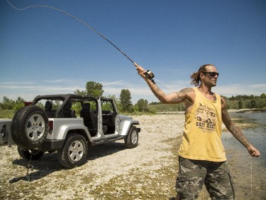 Mike Wagman enjoys an afternoon fly fishing along the Bow River near Graves Bridge in Calgary on Tuesday, June 9, 2015. Wagman said that Tuesday's cooler temperatures, from Monday's record high, makes it possible to enjoy being outside.