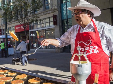 Mayor Naheed Nenshi flips a pancake at Calgary Economic Development's sixth annual First Flip on Stephen Avenue in Calgary on Thursday.