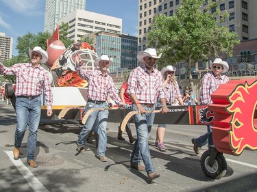 A float for the Flames and Stampeders gets many cheers at the Calgary Stampede Parade in Calgary on Friday, July 3.