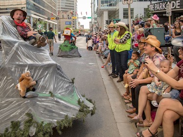 A Parks Canada parade participant proves popular with Calgary Stampede Parade patrons in Calgary on Friday, July 3.