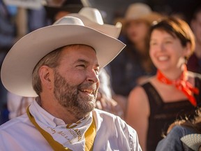Thomas Mulcair, leader of the federal NDPs, prepares to watch the Calgary Stampede Parade in Calgary on Friday, July 3.