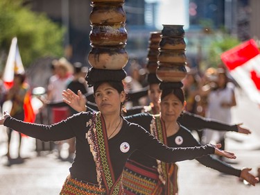 Members of the Filipino community entertain the crowds in the pre-show portion of the Calgary Stampede Parade in Calgary on Friday, July 3.