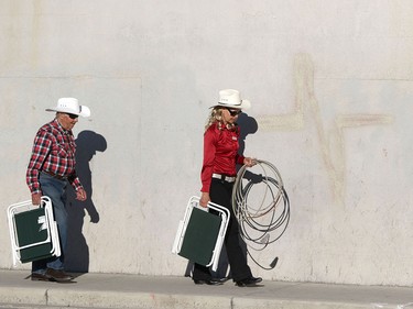 People walk to their spots along the parade route during the Calgary Stampede parade on July 3.